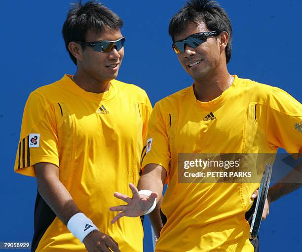 Thai tennis player brothers Sanchai and Sonchat Ratiwatana speak during their mens doubles match against French pair Arnaud Clement and Michale...