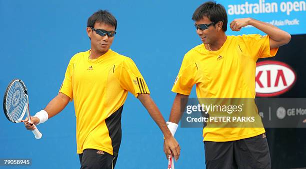 Thai tennis player brothers Sanchai and Sonchat Ratiwatana speak during their mens doubles match against French pair Arnaud Clement and Michale...