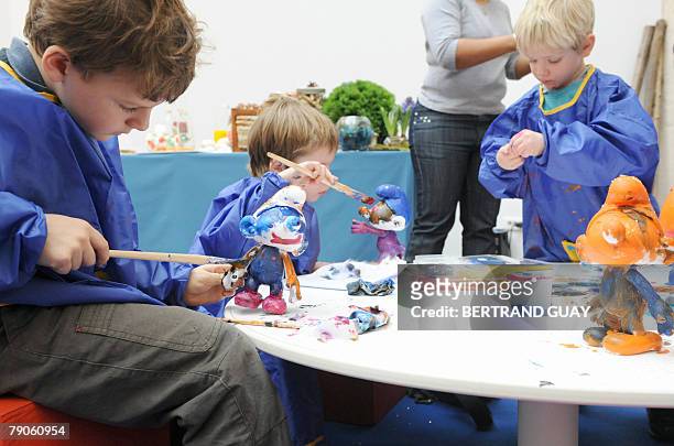 Grandes schtroumpferies pr?vues pour le 50?me anniversaire des Schtroumpfs". Children paint figurines during the celebration of the 50th anniversary...