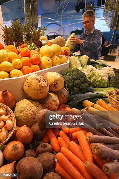 Dr. Ulrike Bickelmann prepares a government-sponsored stand of locally-grown fruits and vegetables at the Gruene Woche agricultural trade fair a day...