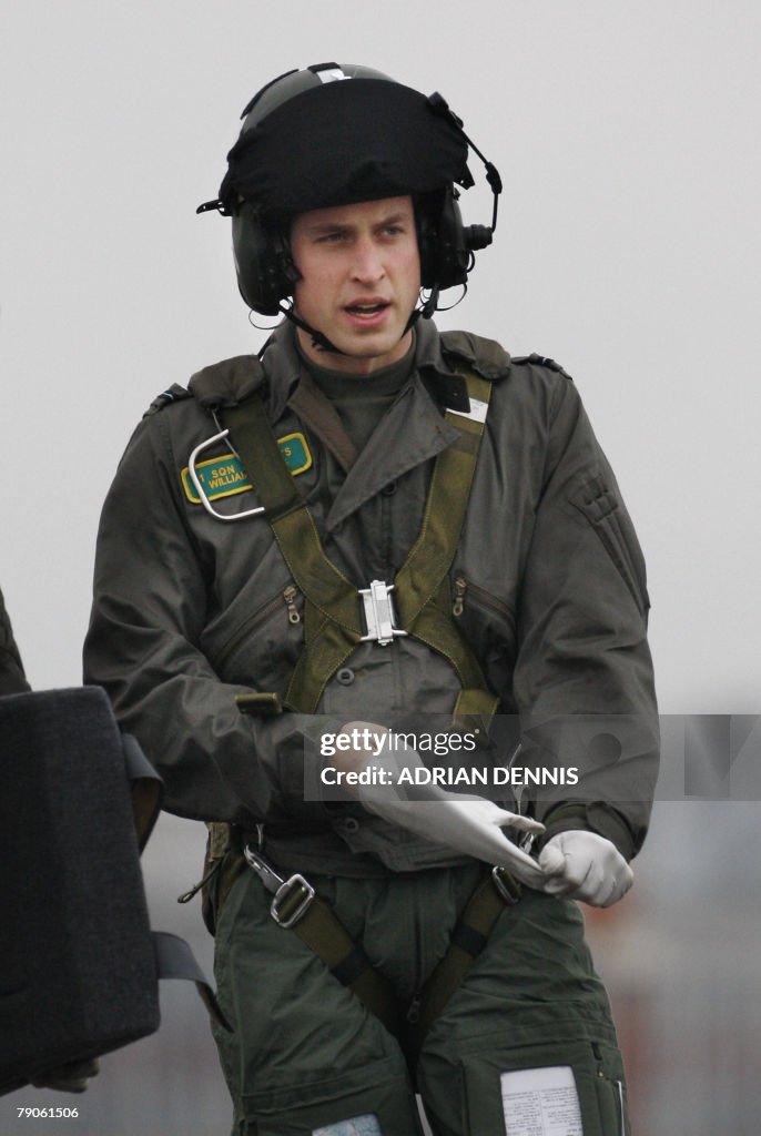 Prince William pulls off his glove after