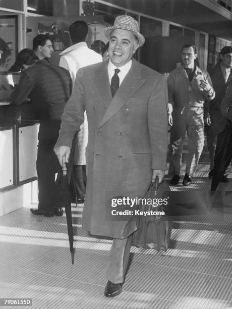 Italian film producer Carlo Ponti leaving Rome on a flight to Paris, 8th January 1959.