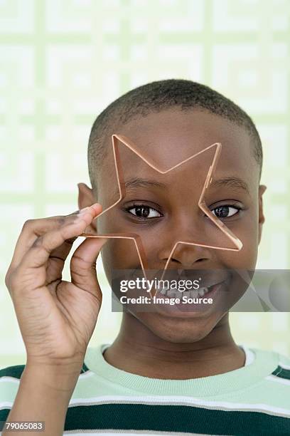 a boy looking through a cookie cutter - cookie cutter stock pictures, royalty-free photos & images