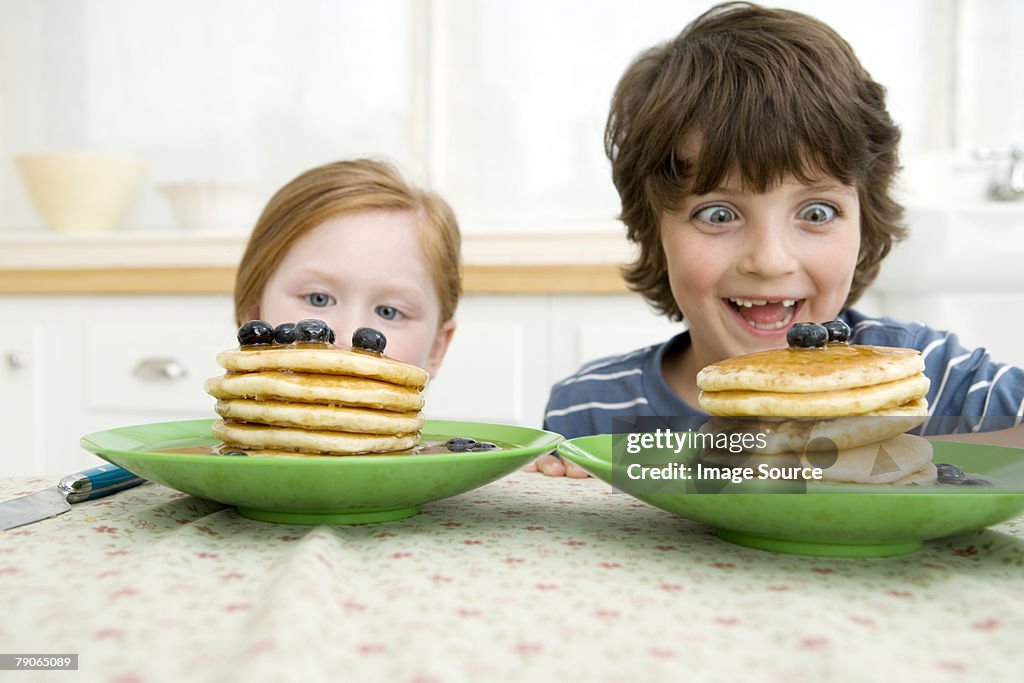Boy and girl looking at pancakes
