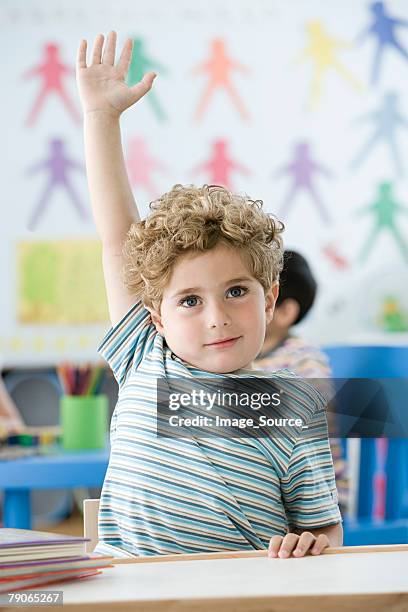 boy raising arm - questioning stock pictures, royalty-free photos & images