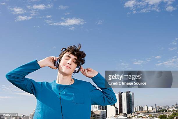 teenage boy listening to music - headphones eyes closed stock pictures, royalty-free photos & images