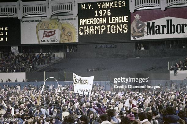 Fans celebrate the New York Yankees victory over the Kansas City Royals in the fifth game of the American League Championship Series on October 14,...