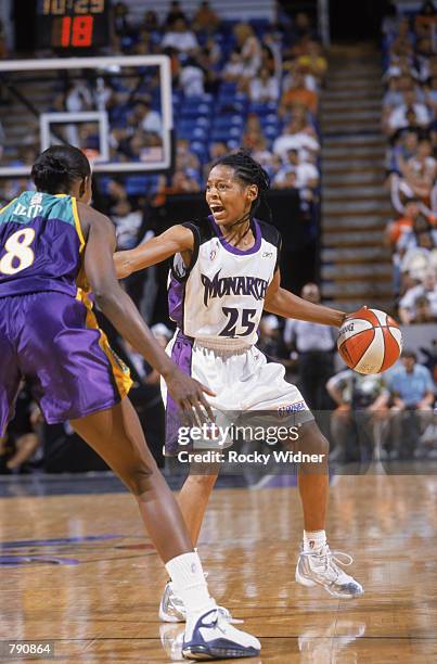 Kedra Holland-Corn of the Sacramento Monarchs dribbles around DeLisha Milton of the Los Angeles Sparks during the WNBA game at Arco Arena in...