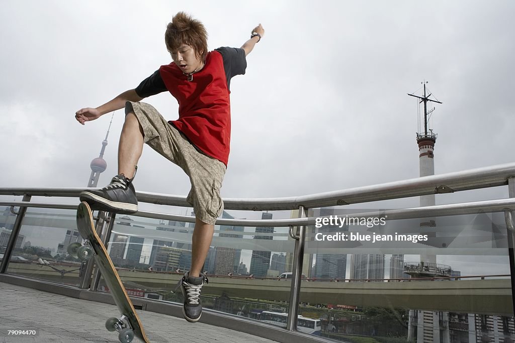 A teenage boy playing skateboard.