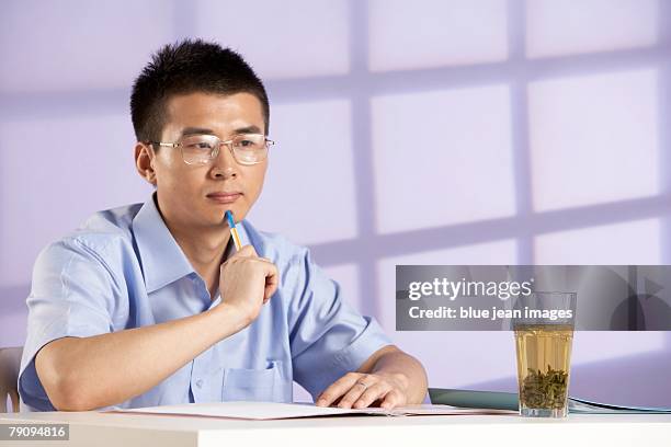 a businessman hard at work. - purple tee shirt stock-fotos und bilder