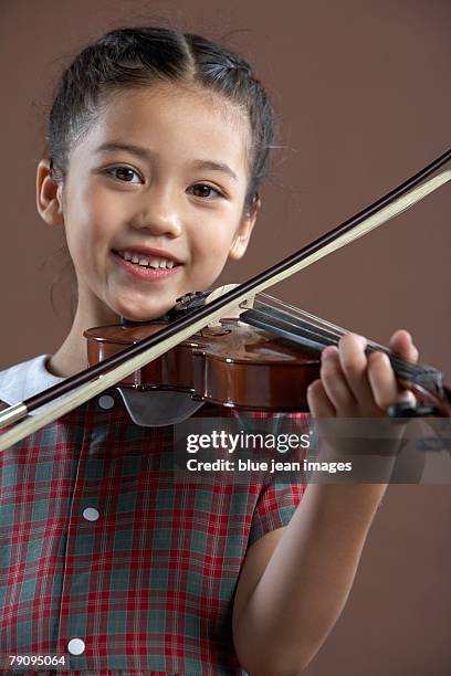 a girl playing the violin. - stereotypically upper class stock pictures, royalty-free photos & images