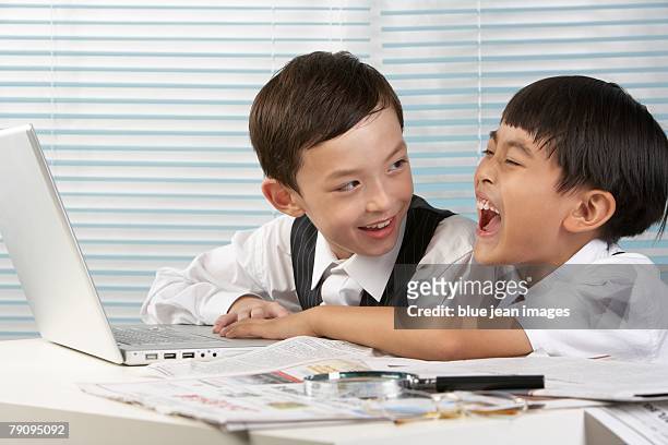 two children using computer. - magnifying glass newspaper watching finance stock market and exchange stock pictures, royalty-free photos & images