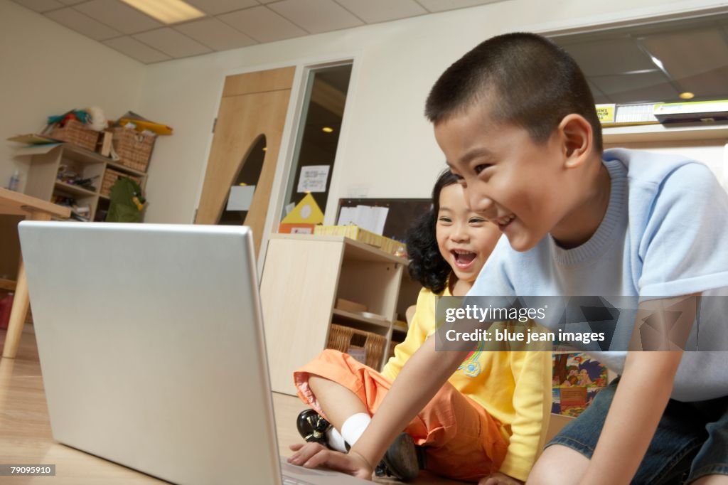 Computer Using Children's Images Two Children Using A Laptop Computer In The Classroom Photo - Getty Images