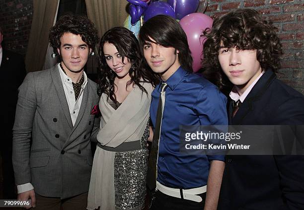 The Jonas Brothers, Kevin , Joe and Nick , pose with actress/singer Miley Cyrus at the afterparty for the premiere of Walt Disney Pictures' "Hannah...