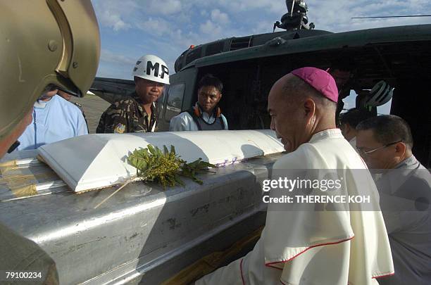 Zamboanga Catholic Archbishop Romulo Valles with priests from Oblates of Mary Immaculate and soldiers carry the casket of the late Catholic priest...