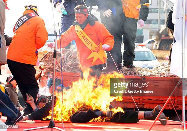 Fish restaurant owner Ji Chang-Hwan, aged 56, sets himself on fire in a suicide attempt during an anti-government and anti-Samsung rally who are...
