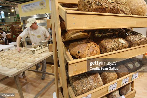 Baker prepares organic bread at a stand at the Gruene Woche agricultural trade fair January 18, 2008 in Berlin, Germany. German demand for organic...