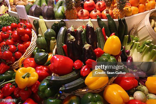 Different kinds of vegetables, including paprikas, zucchini, onions and tomatoes, lie on display at a government stand that offers information on...