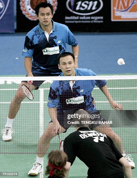 Men's doubles pair Candra Wijaya of Indonesia and Tony Gunawan of the US are all eyes on the shuttlecock as they challenge Denmark's Simon Mollyhus...