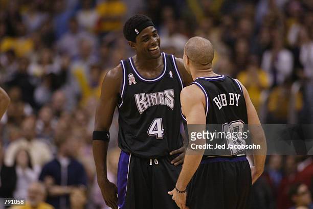 Chris Webber smiles with Mike Bibby of the Sacramento Kings in Game six of the Western Conference Finals during the 2002 NBA Playoffs against the Los...