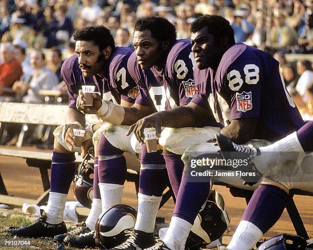 Defensive end Jim Marshall of the Minnesota Vikings sits on the bench next to defensive end Carl Eller and defensive tackle Alan Page against the Los...