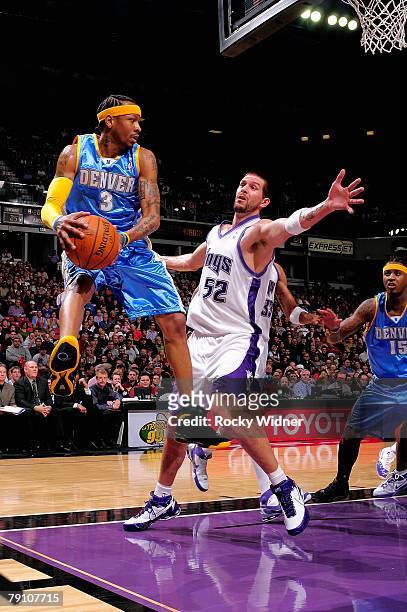 Allen Iverson of the Denver Nuggets looks to pass around Brad Miller of the Sacramento Kings during the game on December 23, 2007 at Arco Arena in...