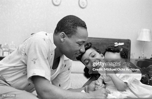 Civil rights leader Reverend Martin Luther King, Jr. Relaxes at home with his wife Coretta and first child Yolanda in May 1956 in Montgomery, Alabama.