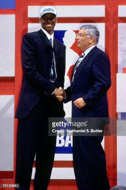 Kobe Bryant poses with NBA Commissioner David Stern after being selected in the first round of the 1996 NBA Draft on June 26, 1996 at Madison Square...