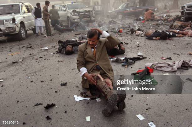 Survivor awaits evacuation immediately after a blast attack on former Prime Minister Benazir Bhutto on December 27, 2007 in Rawalpindi, Pakistan. The...