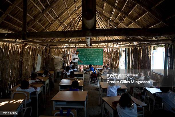 Elias Perez, the director and one of the two teachers at the school on the small island of Isla Corbisky, pop. 200., teaches class in both Spanish...