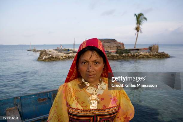 Kuna woman wears paint on her nose, jewlery, and her traditional Molas designed with precise, goemetric figures, while more modern Molas use fish and...