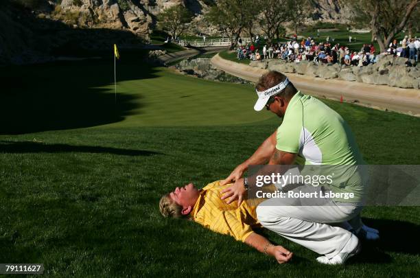 John Daly gets a massage from chronic pain specialist Jim Weathers next to the 17th green during the third round of the 49th Bob Hope Chrysler...