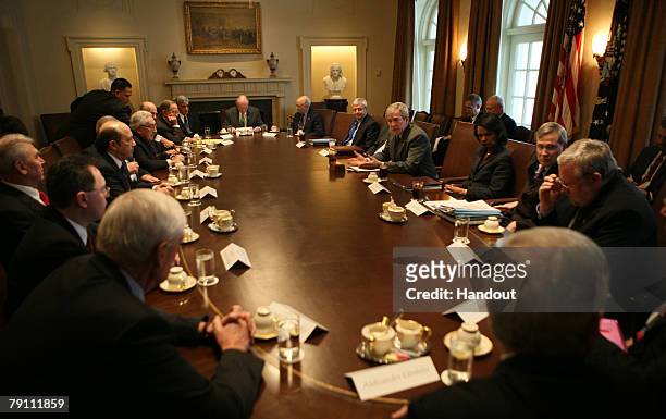 In this handout photo provided by the White House, U.S. President George W. Bush meets with Dr. Henry Kissinger , former Russian Prime Minister...