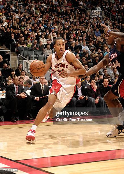 Jamario Moon of the Toronto Raptors drives against Marvin Williams of the Atlanta Hawks at the Air Canada Centre January 18, 2008 in Toronto,...