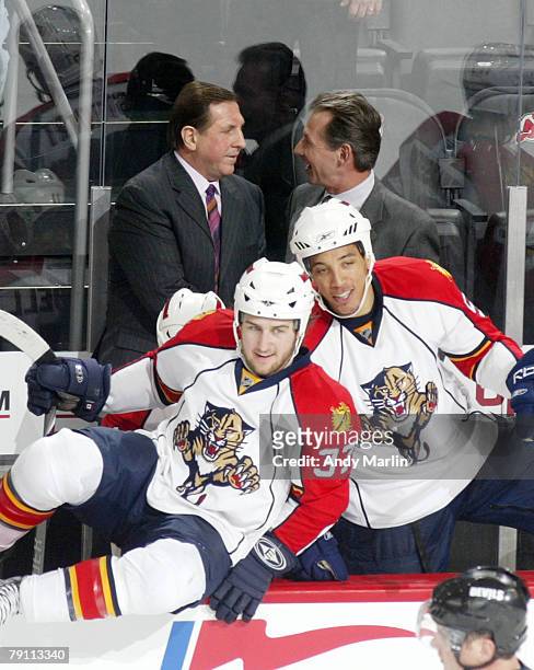 Head coach Jacques Martin of the Florida Panthers is congratulated by his assistant coach Mike Kitchen after the Panthers defeated the New Jersey...