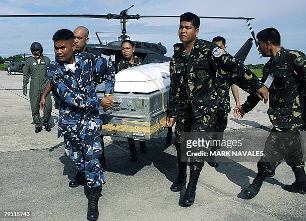 Soldiers carry the casket of the late Catholic priest Father Reynaldo Roda shortly after arriving in his hometown in Cotabato city, 19 January 2008....