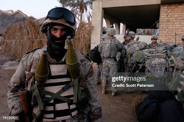 An Iraqi soldier and US Army soldiers of Troop A, 2nd Squadron, 1st Cavalry Regiment prepare to search for Al Qaeda militants in the Diyala River...