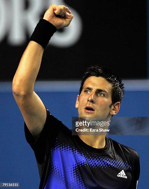 Novak Djokovic of Serbia punches the air in celebration after winning his third round match against Sam Querrey of the United States of America on...