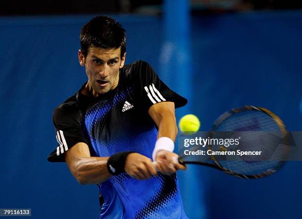 Novak Djokovic of Serbia plays a backhand during his third round match against Sam Querrey of the United States of America on day six of the...