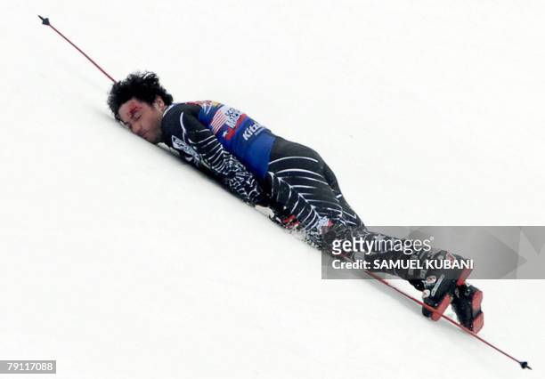 Scott Macartney lies in the finish area after crashing during the men's downhill race during the FIS Ski World cup 19 January 2008 in Kitzbuehel....