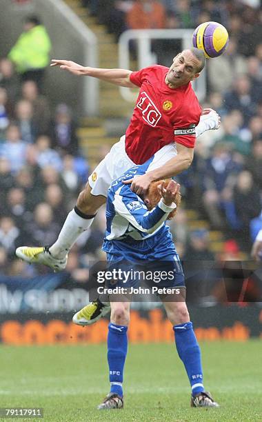 Rio Ferdinand of Manchester United clashes with Dave Kitson of Reading during the Barclays FA Premier League match between Reading and Manchester...