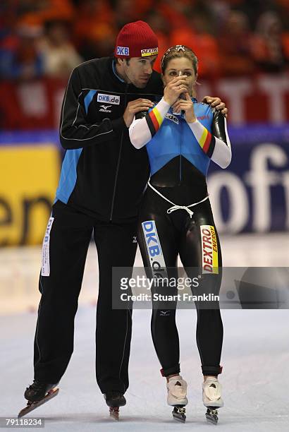 Anni Friesinger of Germany breaths some oxygen as she is congratulated by husband Gianni Romme after winning the ladies 1000m race during the first...
