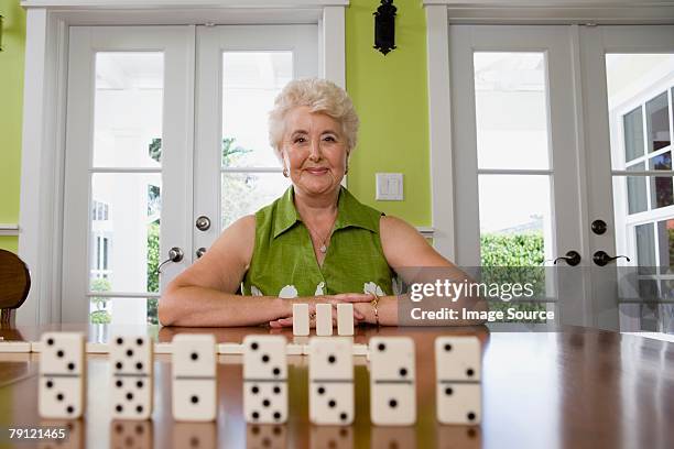 woman playing dominoes - dominoes stock pictures, royalty-free photos & images