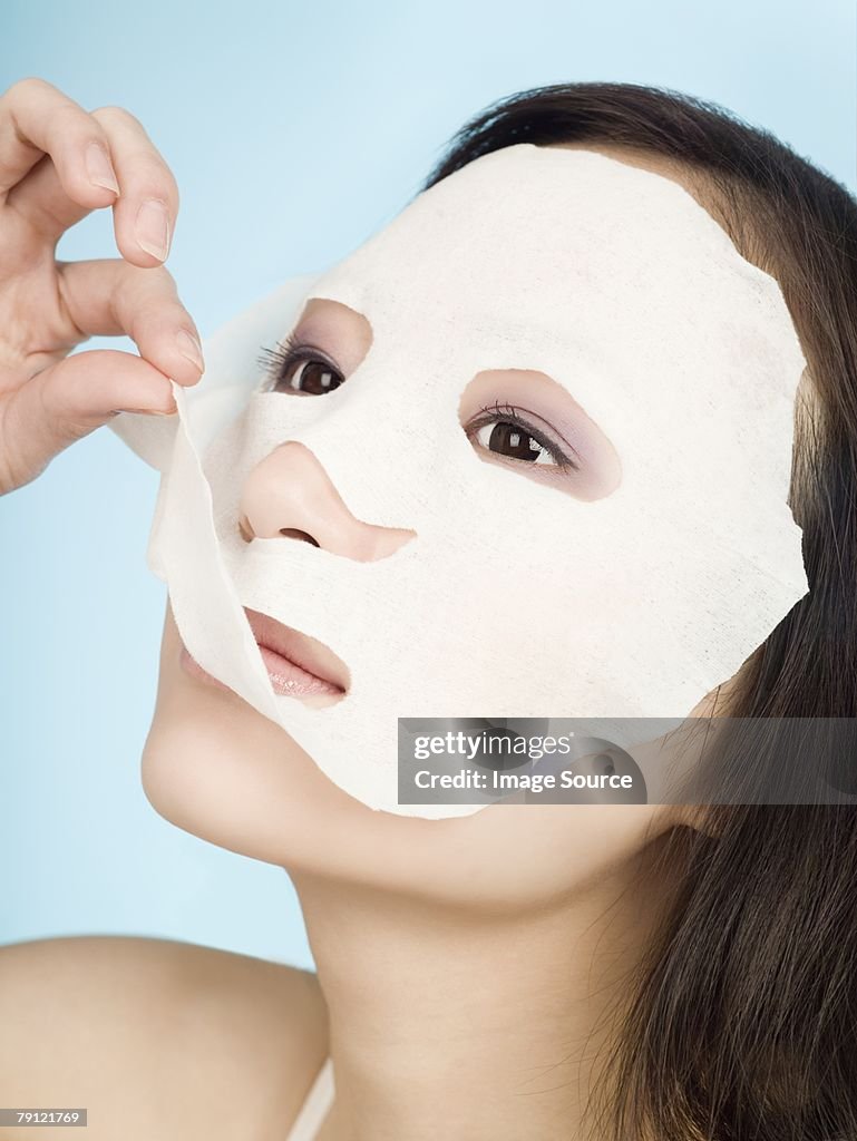 Woman removing face mask