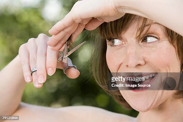 woman trimming her hair - bangs bildbanksfoton och bilder