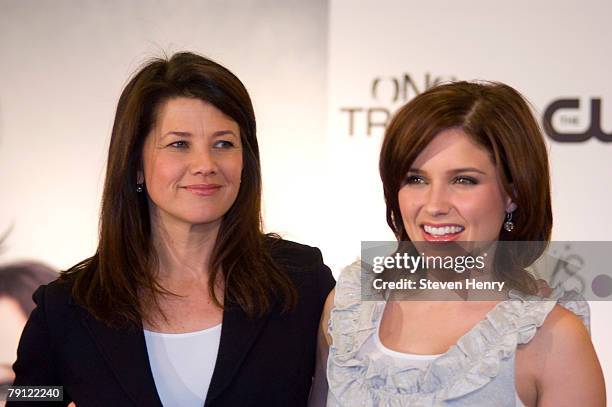 Actresses Daphne Zuniga and Sophia Bush pose on stage at Macy's Herald Square on January 19, 2008 in New York City.