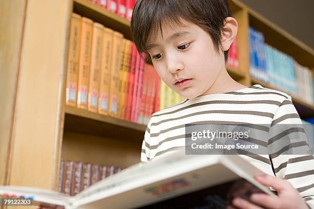 boy reading a book - japanese elementary school bildbanksfoton och bilder