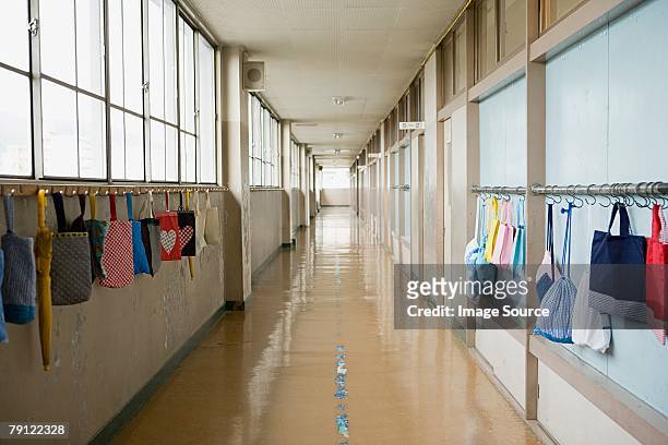 bags hanging in a corridor - corridor bildbanksfoton och bilder