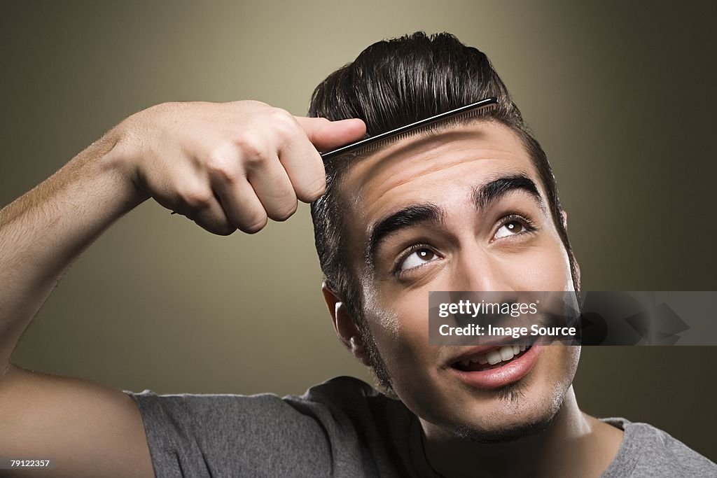 Young man combing his quiff