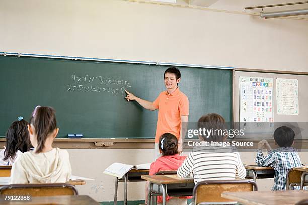 teacher pointing at a blackboard - japanese elementary school bildbanksfoton och bilder